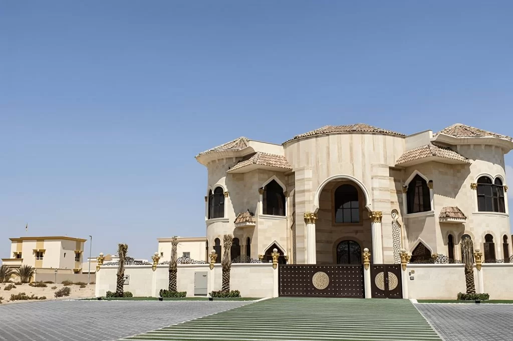 Ornate luxury villa with a large gate.