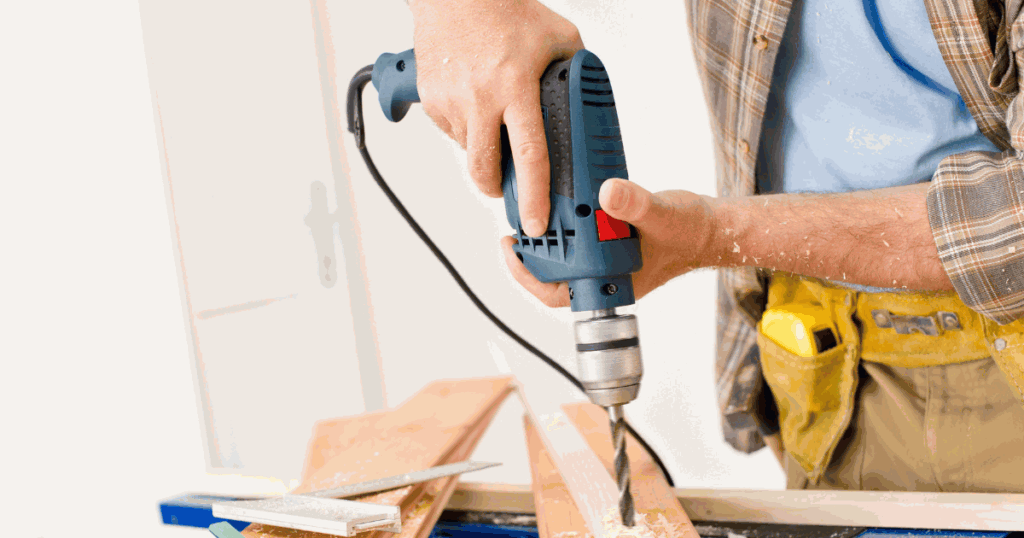Person drilling wood with an electric drill.