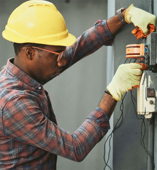 Man working on an electrical panel.