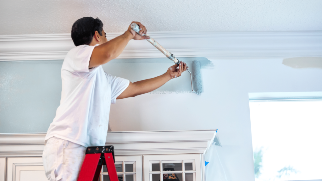 a man painting the house